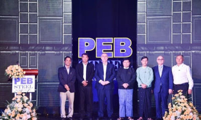 PEB Steel's board of directors take a picture with the delegates